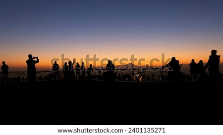people observe and photograph Mount Fuji from the terrace of the Shibuya Sky