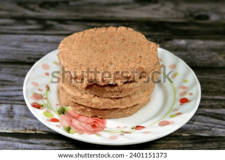 Raw uncooked beef burger ready to be cooked and fried in shallow oil, Fast food, Junk food concept, Home made fast food, beef meat burger ready for frying and served in a burger bun, selective focus
