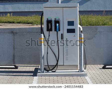 Electric vehicle DC charging station. Network and availability of electric cars charging stations. Types of charging connectors  Royalty-Free Stock Photo #2401154483