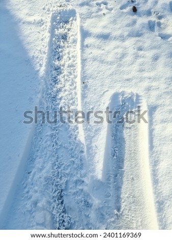 Tire Tracks on snow covered streets in a close up view