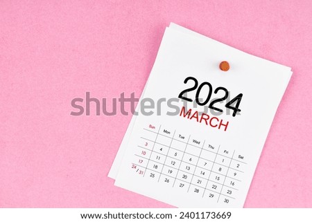 March 2024 calendar page and wooden push pin on pink Color background. Royalty-Free Stock Photo #2401173669