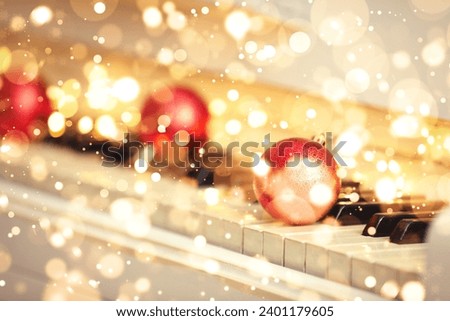 Christmas and New Year music. Piano with festive balls, bokeh effect