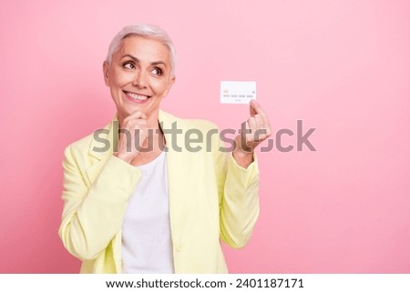 Photo of ceo financial company business woman hold debit plastic card pay look empty space nfc service isolated on pink color background