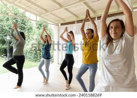 group of women together practicing yoga poses at a spiritual retreat