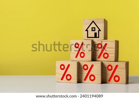 Mortgage rate. Pyramid of wooden cubes with house icon and percent signs on table, space for text