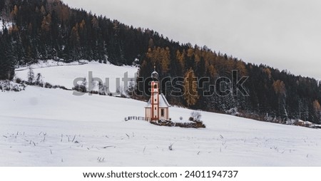 Winterland picture of a landscape with a church in the middle in Dolomites. Chiessetta di San Giovanni in Ranui


