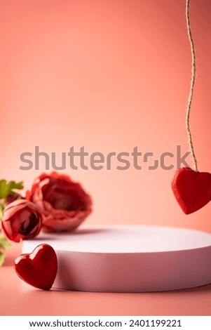 Pink empty podium with red heart over pastel background to show cosmetic products. Minimal romantic backdrop with stand for branding and presentation on Valentine's Day. Royalty-Free Stock Photo #2401199221