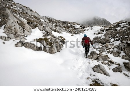 One Woman Conquering Adversity and Beauty of Solo Hiking in High Mountains Out of the Season Royalty-Free Stock Photo #2401214183