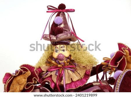 An isolated clown doll on a white background, close-up