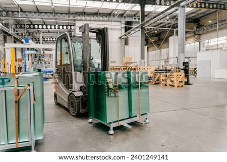 Forklift truck loader in factory with sheet glass in pallets. Glass factory, Production plant