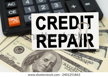 Business concept. On the dollars there is a calculator and a business card with the inscription - CREDIT REPAIR