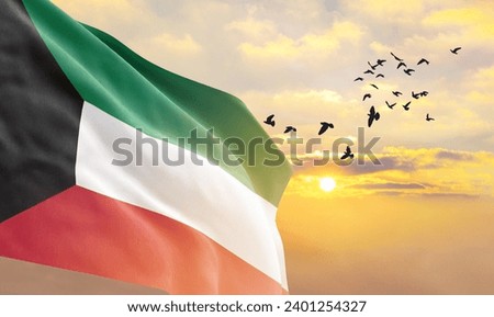 Waving flag of Kuwait against the background of a sunset or sunrise. Kuwait flag for Independence Day. The symbol of the state on wavy fabric. Royalty-Free Stock Photo #2401254327