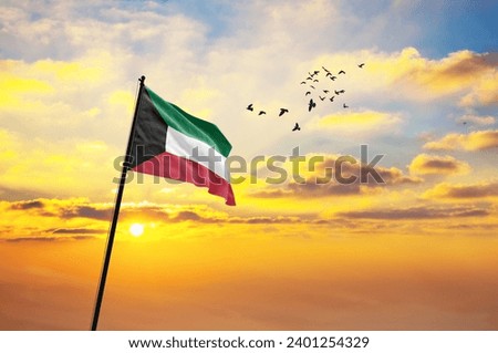 Waving flag of Kuwait against the background of a sunset or sunrise. Kuwait flag for Independence Day. The symbol of the state on wavy fabric. Royalty-Free Stock Photo #2401254329