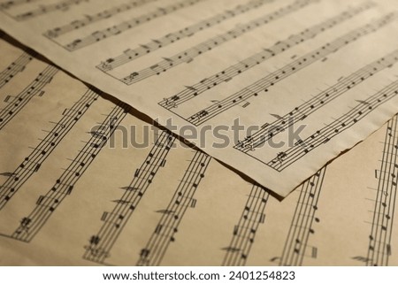 Many old note sheets as background, closeup