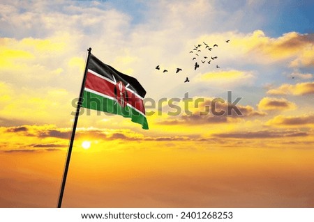 Waving flag of Kenya against the background of a sunset or sunrise. Kenya flag for Independence Day. The symbol of the state on wavy fabric.