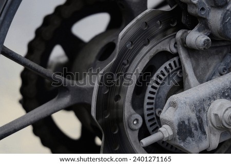 Muddy dirty motorbike rear brake and wheel system
