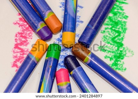 crayons in different colors, green, black, yellow, orange, brown etc.
