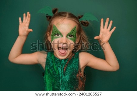 A girl in makeup, in the form of a dragon on a green background
