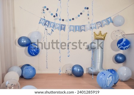 first birthday party decoration with blue balloons for a one year old boy, empty copyspace background