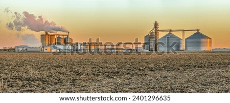 Corn based ethanol plant at sunset in an agricultural landscape.