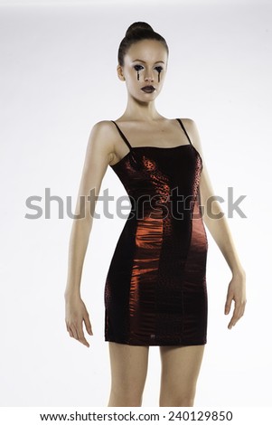 Photo of a beautiful girl in a red dress in the studio on a white background