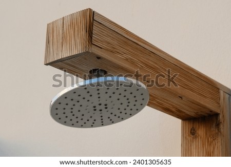 shower head near the pool on the street in a residential complex