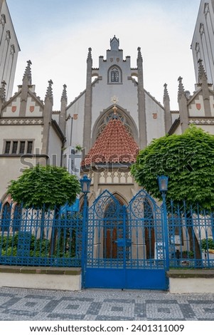 PRAGUE (PRAHA), CZECH REPUBLIC (CZECHIA) – MAY 17, 2023: Beautiful ornate exterior of the Maisel Synagogue (Maiselova synagoga) behind the blue gate, Capital of Prague (Hlavní město Praha) Royalty-Free Stock Photo #2401311009