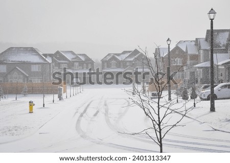 Empty street during heavy snowfall Royalty-Free Stock Photo #2401313347