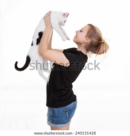 Young beautiful smiling teenager girl with a cat