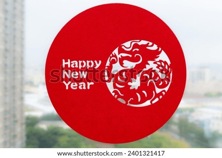 a Chinese New Year of the Dragon decoration to a window at horizontal composition and no logo no trademark