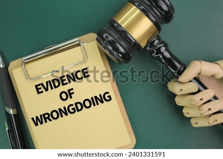 judge's gavel, pen and paper board with the word evidence of wrongdoing. the concept of guilt is proven. concept of evidence  Royalty-Free Stock Photo #2401331591