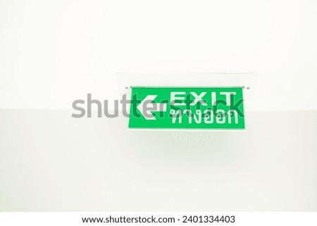 Green emergency exit sign green light box. Thai Letter is Thai Language mean EXIT. Emergency Exit