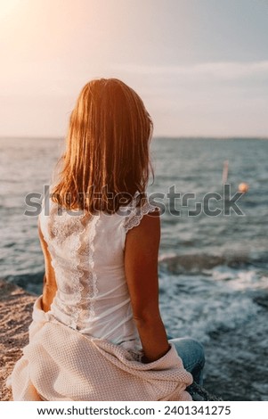 Woman summer travel sea. Happy tourist enjoy taking picture outdoors for memories. Carefree woman traveler posing on beach at sea on sunset, sharing travel adventure journey. Holiday vacation concept.