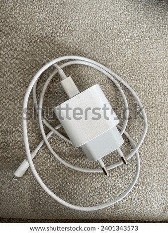 iPhone charger with sofa background