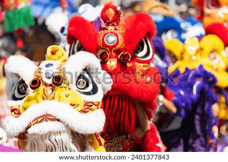 Chinese lion dance show on street in the Chinese New Year festival.Chinese lion costume used during Chinese New Year celebration in China town.Holidays and celebrations concept. Selective focus. Royalty-Free Stock Photo #2401377843