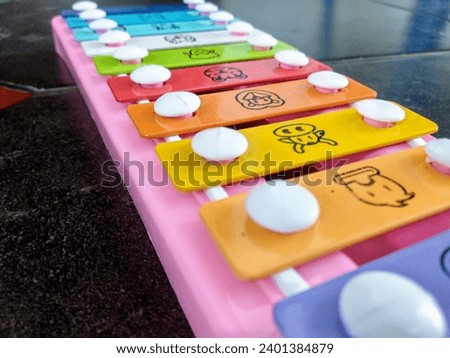 Colorful xylophone for toddlers with animal pictures.