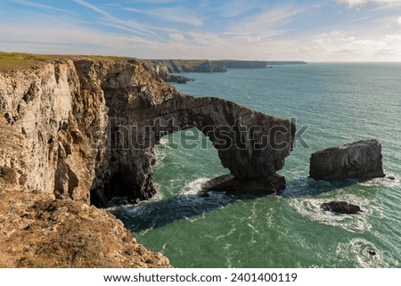 Coast at the Green Bridge of Wales near Castlemartin and Merrion in Pembrokeshire, Wales, UK Royalty-Free Stock Photo #2401400119