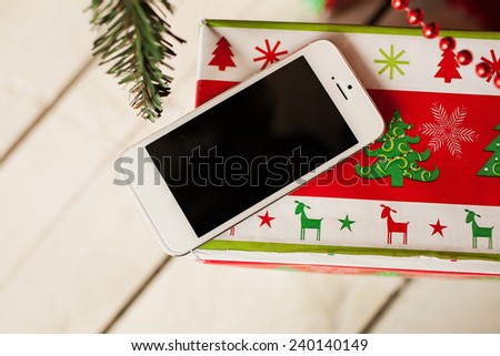 White smartphone with the christmas tree in background