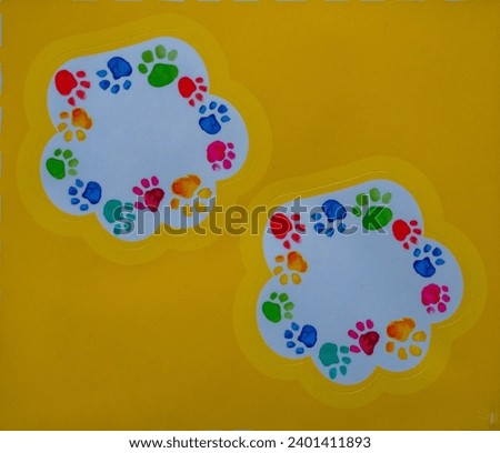 Colored dog paw prints are drawn, on a yellow background