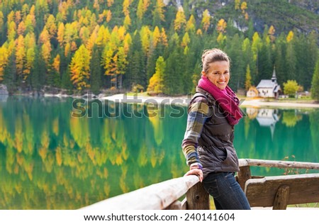 Young woman looking on on lake braies in south tyrol, italy