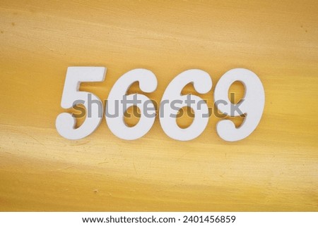 The golden yellow painted wood panel for the background, number 5669, is made from white painted wood.