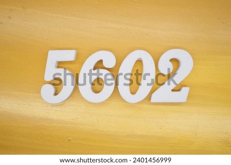 The golden yellow painted wood panel for the background, number 5602, is made from white painted wood.