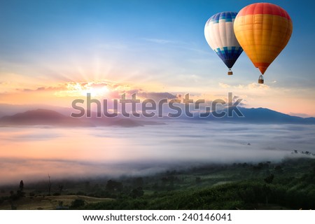 Hot air balloon over sea of mist Royalty-Free Stock Photo #240146041