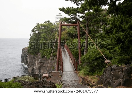 The Kadowaki Suspension bridge looms right above the Jogasaki coast. Royalty-Free Stock Photo #2401473377