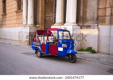 A traditional ape taxi on the streets of Palermo, Italy. Royalty-Free Stock Photo #2401474177