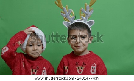 Naughty brothers inviting santa to come. Dancing and making funny face expressions. High quality photo