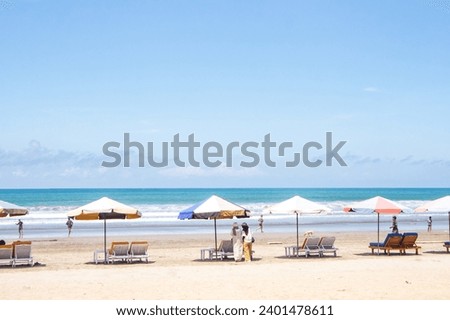 The atmosphere at Kuta Beach, Bali, in the photo during a sunny day