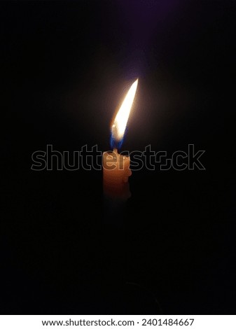 It is picture of a candle in dark taken with samsung J4 plus mobile phone