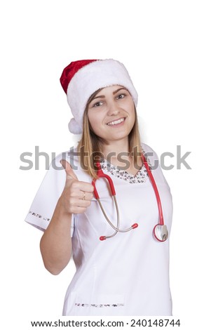 Beautiful young doctor (or nurse) with red Santa hat wearing red stethoscope, isolated on white background