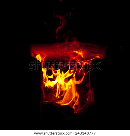 Flames erupt from the combustion chamber of the furnace, on a black background